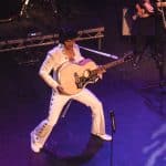 Elvis impersonator JD King on stage with guitar at Wakefield Theatre Royal