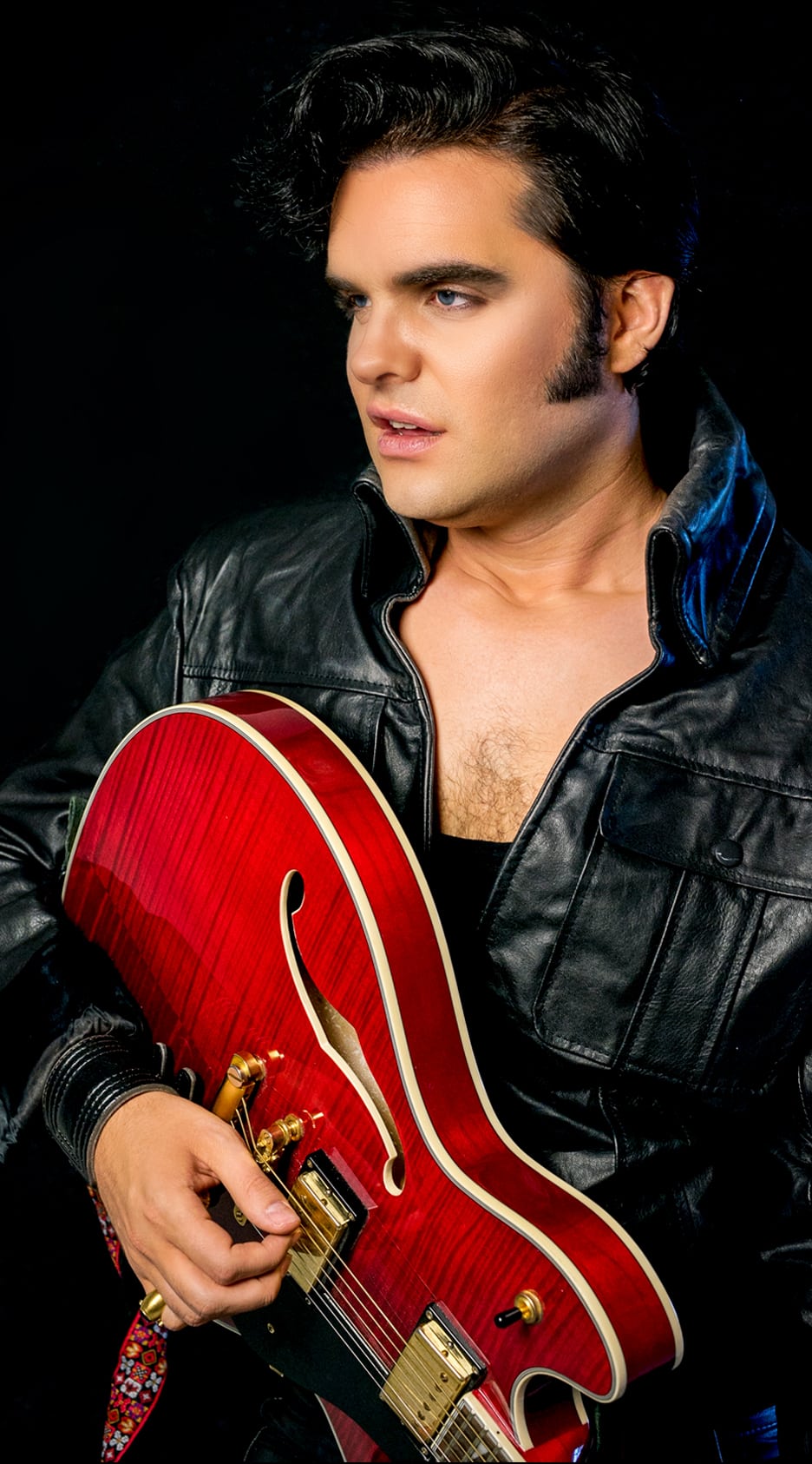 Elvis impersonator JD King 68 comeback special black leather with red guitar